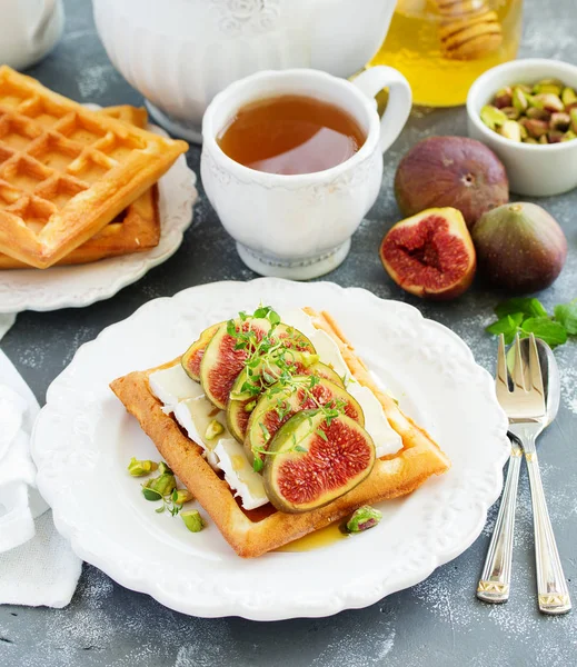 Wafers with figs, brie cheese and honey. Delicious wholesome breakfast.