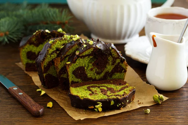 Chocolate pistachio cake with frosting.