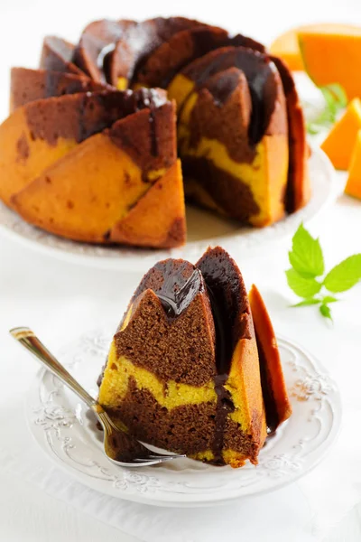 Pumpkin chocolate cake with frosting.