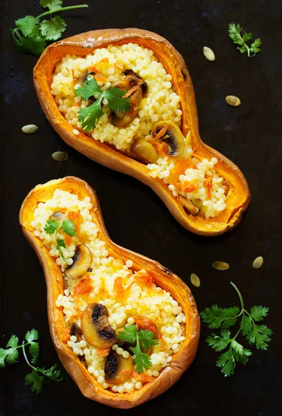 Pumpkin stuffed with couscous with grilled mushrooms.