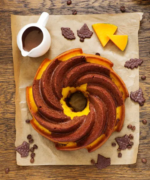 Pumpkin chocolate cake with frosting.