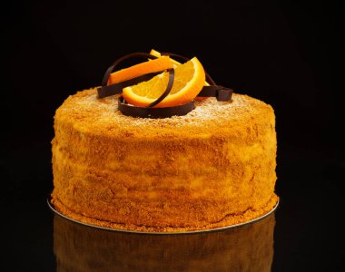 Turuncu beyaz bir tabağa krem ile ev yapımı tatlım pasta.