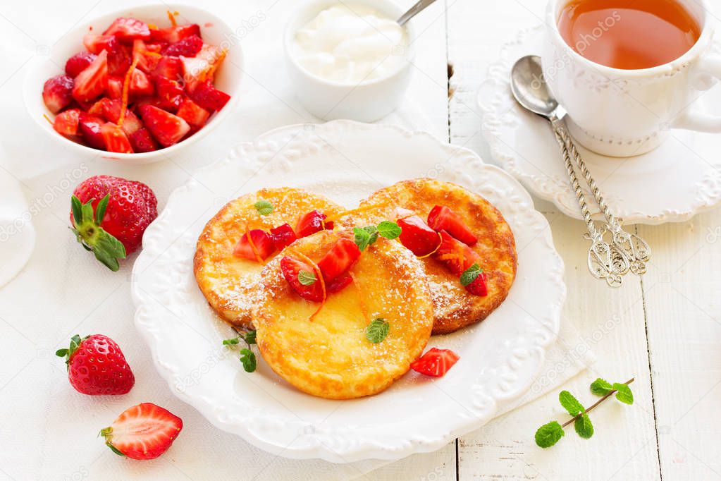 cottage cheese pancakes (cheese cakes) with strawberries and cream.