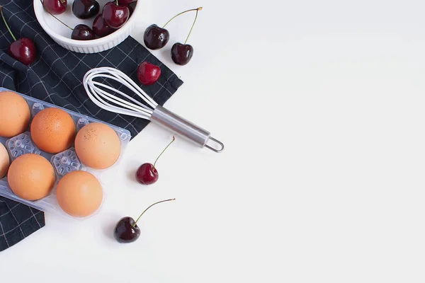 Raw Eggs Whisk Baking Mold Checkered Black Napkin Ripe Cherries — Stock Photo, Image