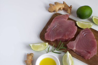 Ham orkinos biftek ahşap cutboard kireç dilim zeytin yağı Rosemary Fresh zencefil kökü izole beyaz arka plan kopya alanı üstten görünüm madde sağlıklı Asya yemek yemek Protein düz yatıyordu