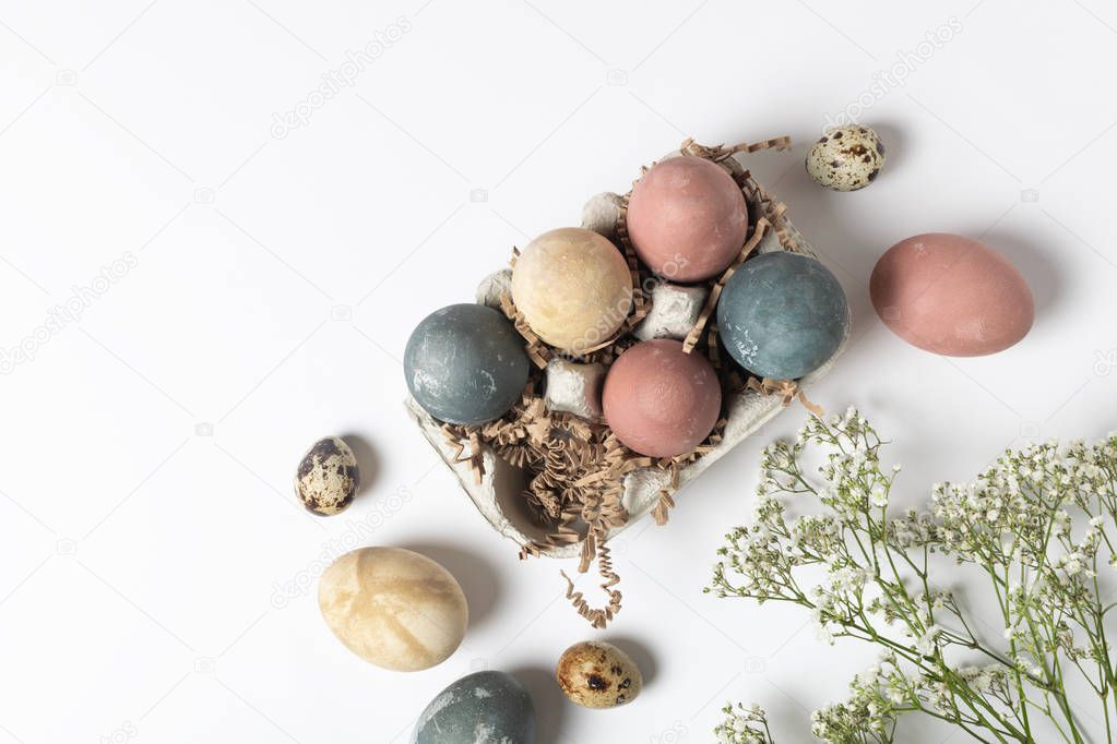 Selective focus of coloured decorated easter eggs in cardboard c