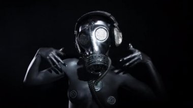 Seksi kadın gümüş gövde boya ve gaz maskesi siyah arka planda dans