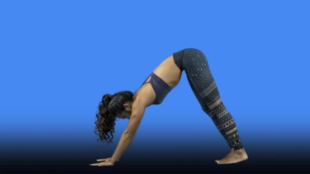 Young Woman Doing Yoga Blue Background — Stock Video