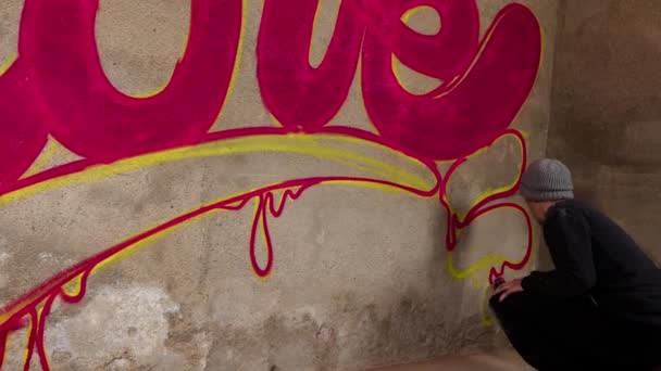 Process Graffiti Artist Spraying Word Love Concrete Wall — Stock Video