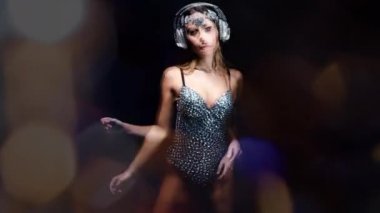 Siyah arka planda hareket eden vücut ve kulaklık güzel kadın