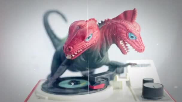 Toy dinosaur spinning discs on record player — Stock Video