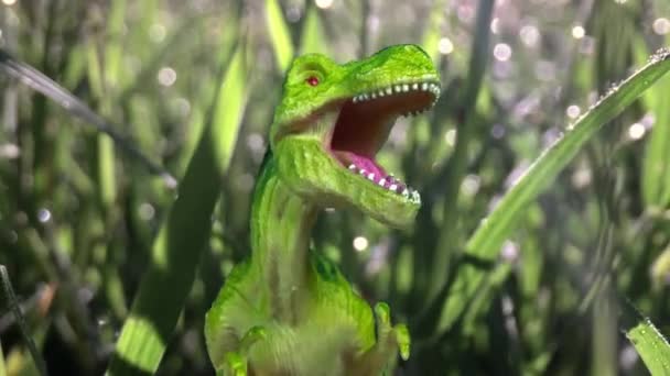 Toy dinosaur in green foliage — Stock Video