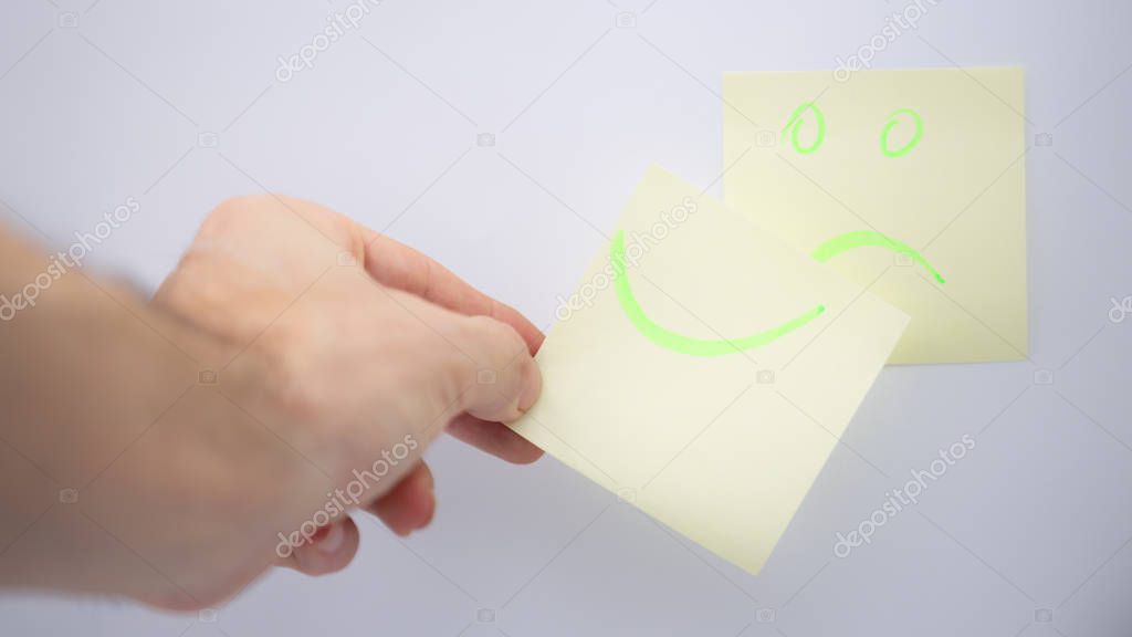 in the white background and empty space the smile in the memo  like concept of emotions and hand