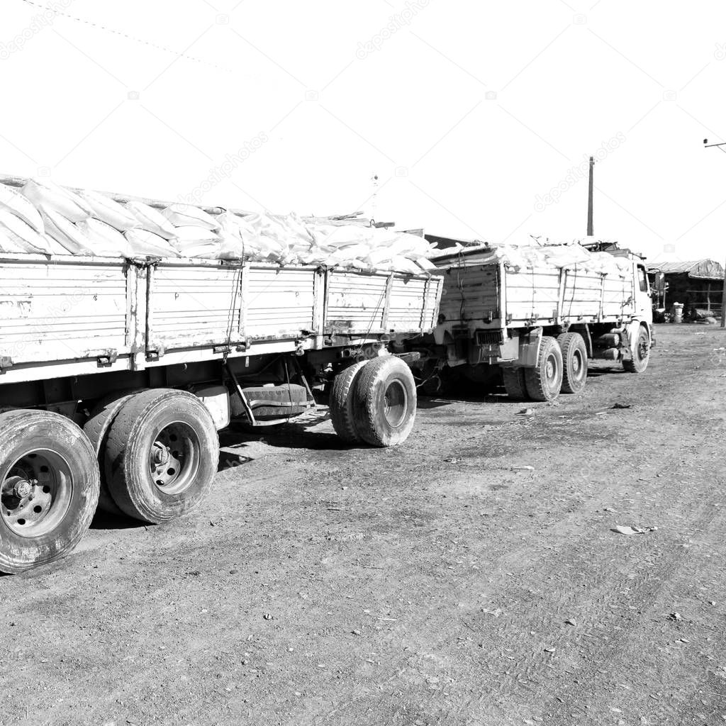 in  danakil ethiopia  africa  in the land of afar the  truck full of bags of salt near the village and flats