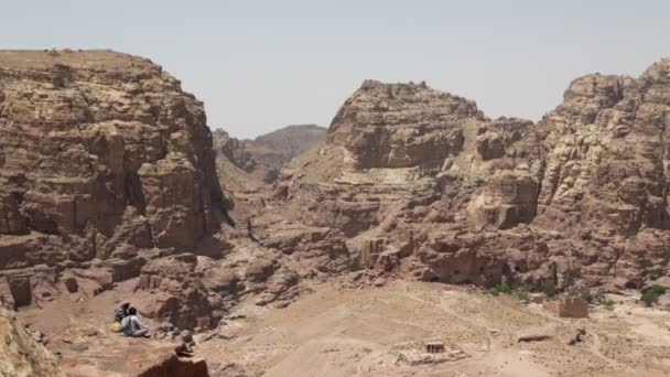 ヨルダンの高い岩からペトラのアンティークのサイトで探している人々 — ストック動画