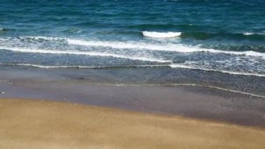 okyanus dalgaları ve kumlu plaj manzarası
