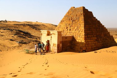 SUDAN, MEROE-CIRCA DECEMBER 2018--unidentified people in the antique ruin clipart