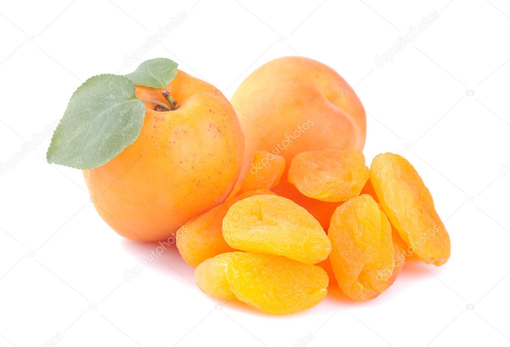 Ripe fresh apricots with a leaf and dried apricots on a white isolated background