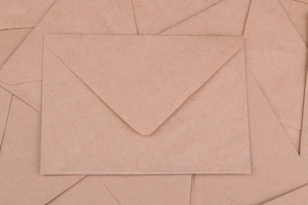 Background from mail envelopes from craft paper. view from above. mail or delivery concept