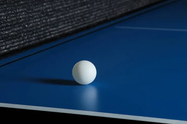 Ping-pong ball on a blue table tennis table. Sport. Sport game