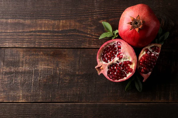 Composition Ripe Pomegranate Fruit Green Leaves Brown Wooden Background Top — Stock Photo, Image