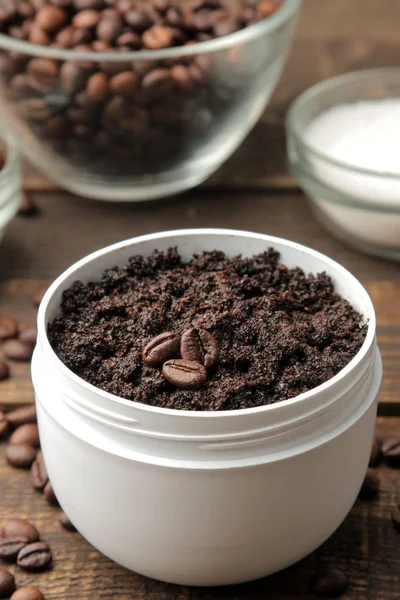 homemade coffee scrub in a white jar for the face and body and various ingredients for making scrub. spa. cosmetics. care cosmetics