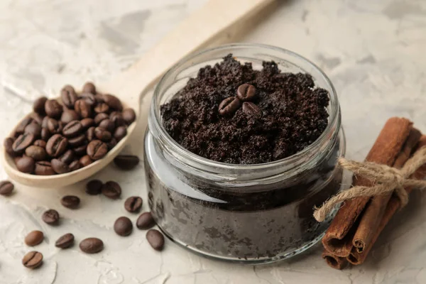 homemade coffee scrub in a jar for the face and body, and various ingredients for making scrub on a light background. spa. cosmetics. care cosmetics.