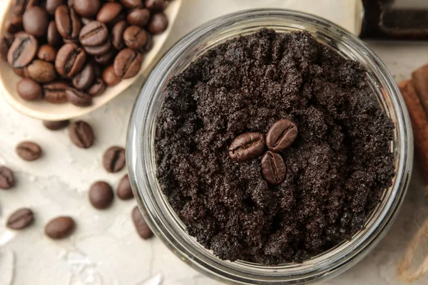 homemade coffee scrub in a jar for the face and body, and various ingredients for making scrub on a light background. spa. cosmetics. care cosmetics. view from above