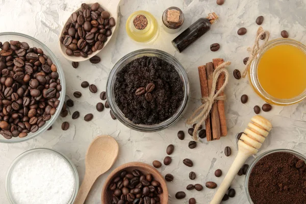 homemade coffee scrub in a jar for the face and body, and various ingredients for making scrub on a light background. spa. cosmetics. care cosmetics. view from above