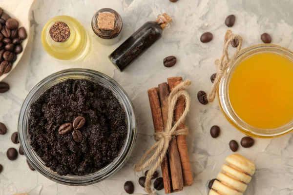 homemade coffee scrub in a jar for the face and body, and various ingredients for making scrub on a light background. spa. cosmetics. care cosmetics. view from above