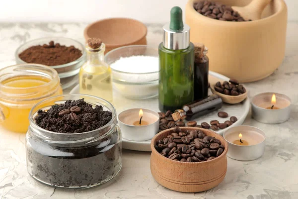 homemade coffee scrub in a jar for the face and body, and various ingredients for making scrub on a light background. spa. cosmetics. care cosmetics.