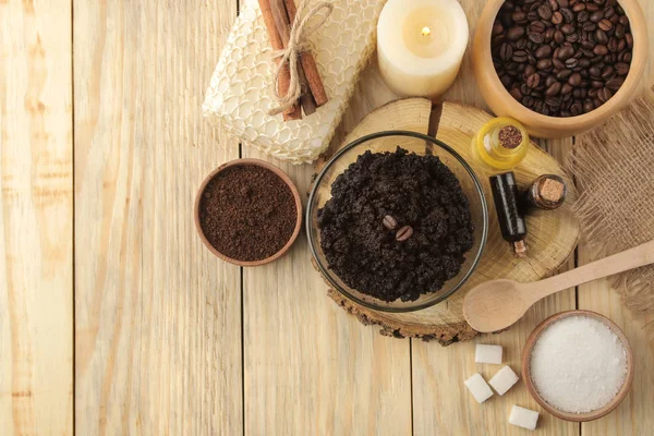homemade coffee scrub in the face and body bowl and various ingredients for making scrub on a wooden table. spa. cosmetics. care cosmetics. top view with space for text
