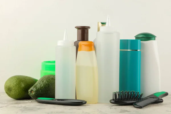 Various hair care products and various hair accessories on a light background. hair cosmetics.