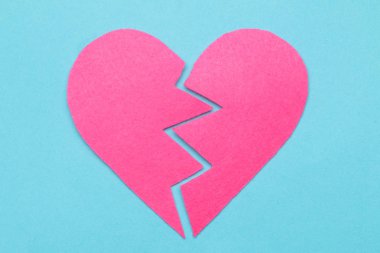 Pembe kalp parlak mavi bir arka plan üzerinde kırık. kırık aşk