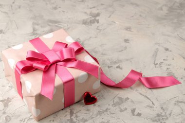 Pembe hediye kutuları ve kalpleri hafif bir beton zemin üzerinde yakın çekim. Sevgililer günü. metin için yer