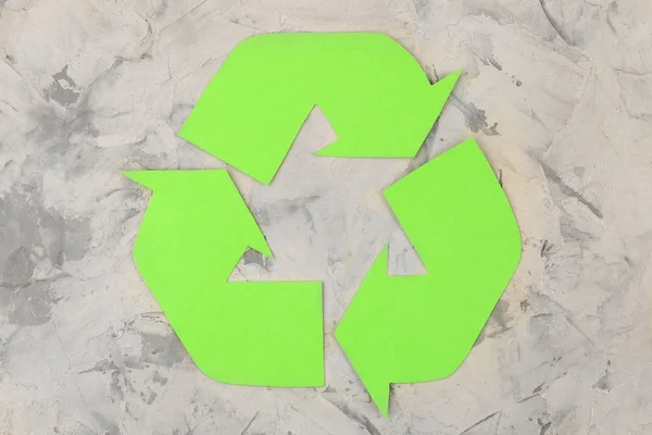 Recycling sign on light concrete background. view from above. eco concept