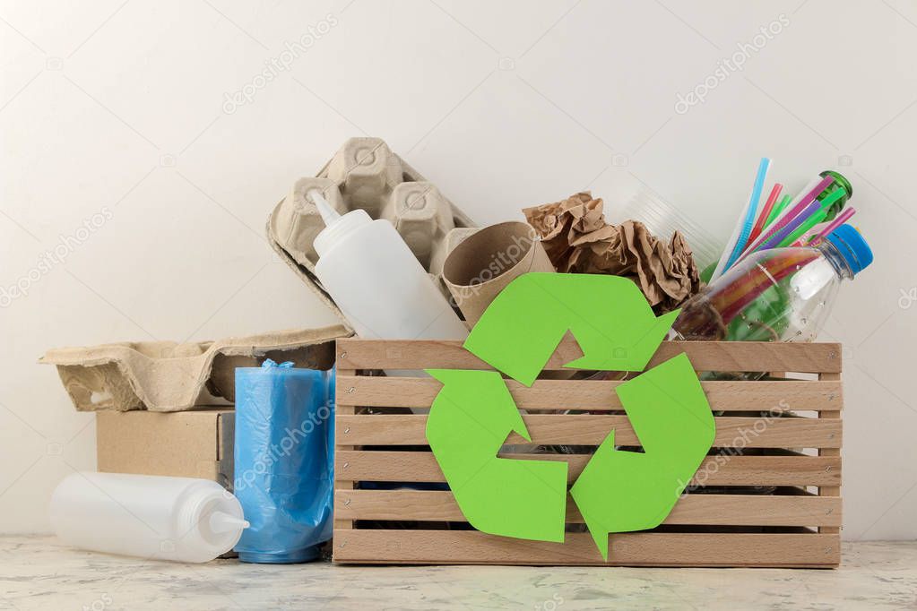Eco symbol and trash in the box. recycling. waste recycling. on a light background