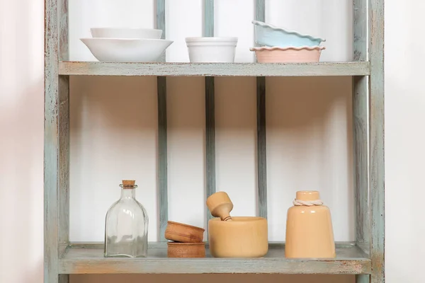 Vintage shelf with kitchenware on a white wall background. antique shelf. interior