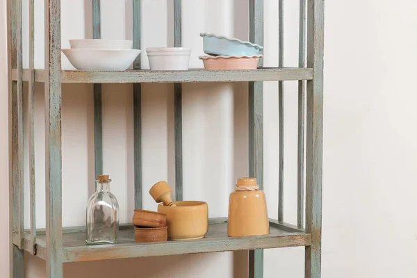 Vintage shelf with kitchenware on a white wall background. antique shelf. interior