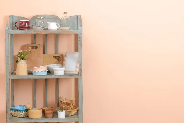 Vintage shelf with kitchenware in the background of the peach wall. antique shelf. interior