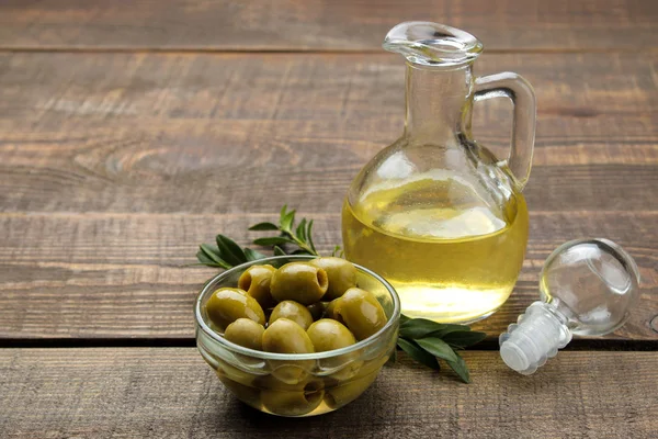 Green Olives Olive Oil Leaves Brown Wooden Table Space Text — Stock Photo, Image