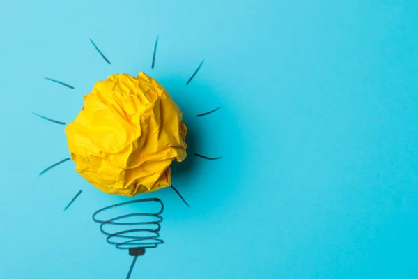 Concept creative idea. concept of creative idea. Crumpled paper balls and painted light bulb on bright background. metaphor, inspiration.