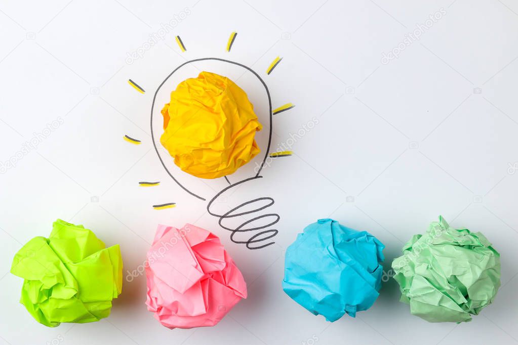 Concept creative idea. concept of creative idea. Crumpled paper balls and painted light bulb on bright background. metaphor, inspiration.