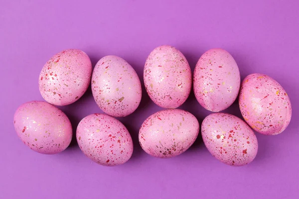 Easter. Pink Easter eggs on trendy purple background. Happy easter. holidays. top view