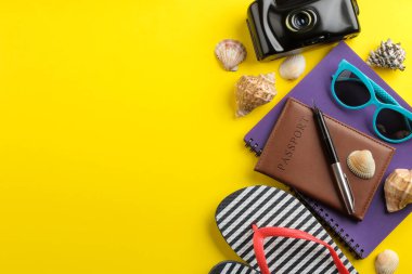 Seyahat kavramı. Pasaport, harita, fotoğraf makinesi ve parlak sarı bir arka plan üzerinde gözlük. Üstten Görünüm. metin için yer