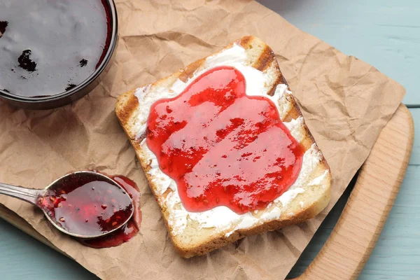 toasts with jam. fried crispy toast with red jam on a blue wooden table. breakfast. top view
