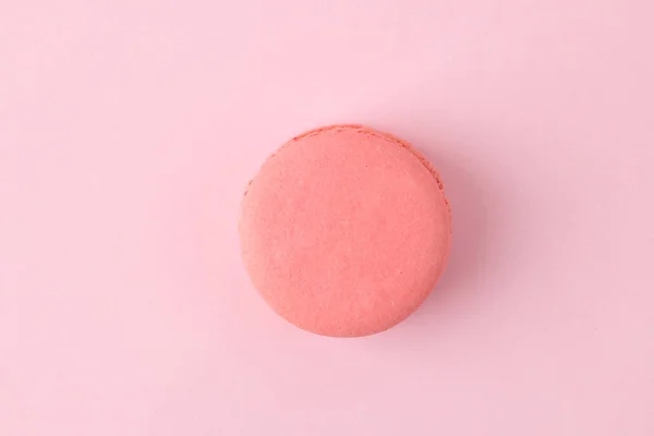 Macarons. french multicolored macaroons cakes. small french sweet cake on bright pink background. Dessert. Sweets. top view. minimalism