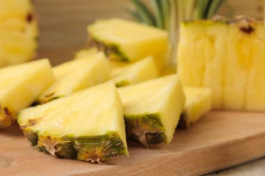 Doğal bir ahşap arka plan üzerinde taze olgun ananas yarım ve ananas dilimleri. Yaz. Meyve.