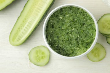 Salatalıklı yüz maskesi. Beyaz ahşap bir masa üzerinde salatalık özü ile Kozmetik. Spa. Güzellik. üst görünüm