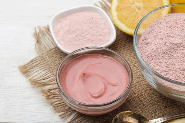 Cosmetic clay. Pink cosmetic clay in different types on a white wooden table. face mask and body. care products. spa.